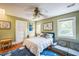 Bedroom featuring green walls, hardwood floors, and a bed with white bedding at 1213 Pierce St, Raleigh, NC 27605