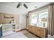 Bright bedroom featuring neutral walls, a ceiling fan, hardwood floors, and plenty of natural light at 1213 Pierce St, Raleigh, NC 27605