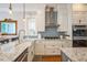 Well-equipped kitchen featuring granite countertops, gas range, stainless steel appliances, and stylish cabinetry at 1213 Pierce St, Raleigh, NC 27605