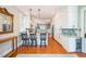 Spacious kitchen with white cabinetry, granite countertops, wood floors and stainless steel appliances at 1213 Pierce St, Raleigh, NC 27605