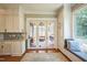 Elegant kitchen with white cabinetry, breakfast nook, and access to the sunroom at 1213 Pierce St, Raleigh, NC 27605
