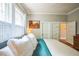 Bright main bedroom with natural light, shutters, hardwood floors, and white bedding at 1213 Pierce St, Raleigh, NC 27605