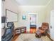 Office with a work space, chair, and a view into a bedroom with hardwood floors at 1213 Pierce St, Raleigh, NC 27605