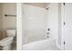 Modern bathroom featuring a white tiled shower-tub combination and a matching toilet at 150 Purslane Dr, Franklinton, NC 27525