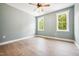 Bright bedroom with hardwood floors, a ceiling fan, and two windows at 150 Purslane Dr, Franklinton, NC 27525