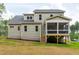 Back of home showing the screened porch, light green siding and the backyard at 150 Purslane Dr, Franklinton, NC 27525