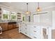 Bright, functional kitchen with an island, floating shelves, and stylish pendant lighting at 150 Purslane Dr, Franklinton, NC 27525