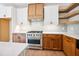 Kitchen featuring stainless steel range, custom cabinetry, and open shelving at 150 Purslane Dr, Franklinton, NC 27525