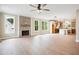 Open-concept living room with a brick fireplace, hardwood floors, and natural light at 150 Purslane Dr, Franklinton, NC 27525