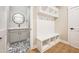 Bright mudroom with storage, bench, and sink area with patterned tile at 150 Purslane Dr, Franklinton, NC 27525
