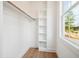 Walk-in closet with built-in shelving and rod, and a view of the yard at 150 Purslane Dr, Franklinton, NC 27525