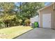 A lush backyard with a well manicured lawn, patio area and mature trees at 1505 Poets Glade Dr, Apex, NC 27523
