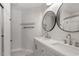 This bathroom features a double vanity sink, round mirrors, and marble tile flooring at 1505 Poets Glade Dr, Apex, NC 27523