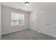 Bedroom with carpet, window, base-molding, and double door closet at 1505 Poets Glade Dr, Apex, NC 27523