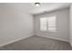 This bedroom features neutral walls, carpet, one window, and a ceiling light at 1505 Poets Glade Dr, Apex, NC 27523