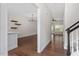 Bright entryway with hardwood floors flowing into dining area with modern chandelier at 1505 Poets Glade Dr, Apex, NC 27523