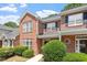 Attractive brick townhome exterior with lush landscaping and inviting curb appeal at 1505 Poets Glade Dr, Apex, NC 27523