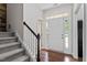 Welcoming foyer featuring a staircase and ample natural light from the front door at 1505 Poets Glade Dr, Apex, NC 27523