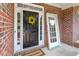 Classic black front door adorned with a cheerful yellow wreath and a new door at 1505 Poets Glade Dr, Apex, NC 27523