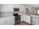 Modern kitchen features white cabinetry, stainless steel appliances, and quartz countertops at 1505 Poets Glade Dr, Apex, NC 27523