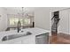 Kitchen with eat-in area, stainless steel appliances and views to the living room and staircase at 1505 Poets Glade Dr, Apex, NC 27523