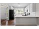 Well-lit kitchen with white cabinetry, modern appliances, and ample counter space at 1505 Poets Glade Dr, Apex, NC 27523