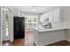 Bright kitchen with white cabinets, stainless appliances, and hardwood floors at 1505 Poets Glade Dr, Apex, NC 27523