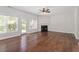Spacious living room with fireplace, ceiling fan, hardwood floors and lots of natural light at 1505 Poets Glade Dr, Apex, NC 27523