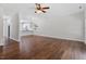 Open living room with hardwood floors and views to the kitchen area at 1505 Poets Glade Dr, Apex, NC 27523