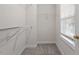 This walk-in closet features metal shelving, carpet and a window with blinds at 1505 Poets Glade Dr, Apex, NC 27523