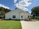Rear exterior view highlighting the home's well-kept lawn and back entry at 172 W Old Rd, Lillington, NC 27546
