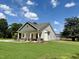 Exterior view of the home with a beautiful lawn and a covered front porch at 172 W Old Rd, Lillington, NC 27546