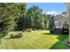Spacious backyard with a deck and sunroom, ideal for outdoor entertaining and relaxation at 175 Georgetown Woods Dr, Youngsville, NC 27596