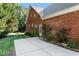 Brick home featuring a patio area, perfect for outdoor relaxation, and green landscaping at 175 Georgetown Woods Dr, Youngsville, NC 27596