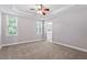 Spacious bedroom with large windows, a ceiling fan, and plush carpet at 175 Georgetown Woods Dr, Youngsville, NC 27596
