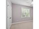 Bedroom with plush carpet, large windows and a ceiling fan with lights at 175 Georgetown Woods Dr, Youngsville, NC 27596