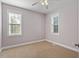Bedroom featuring neutral tones, plush carpet, and large windows for natural light at 175 Georgetown Woods Dr, Youngsville, NC 27596