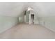 Large bonus room featuring neutral carpet, ceiling fan, and several entry doors at 175 Georgetown Woods Dr, Youngsville, NC 27596