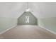 Spacious bonus room with neutral carpet, ceiling fan, and natural light at 175 Georgetown Woods Dr, Youngsville, NC 27596