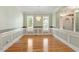 Formal dining room with wainscoting, hardwood floors, decorative lighting, and plenty of sunlight at 175 Georgetown Woods Dr, Youngsville, NC 27596