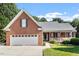 Charming brick home featuring a two-car garage and inviting front porch at 175 Georgetown Woods Dr, Youngsville, NC 27596