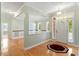 Bright foyer with hardwood floors, chandelier lighting, and an open floorplan to the dining room at 175 Georgetown Woods Dr, Youngsville, NC 27596