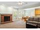 Cozy living room with fireplace, carpeted flooring, and access to an adjacent kitchen and dining area at 175 Georgetown Woods Dr, Youngsville, NC 27596