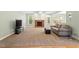 Spacious living room features a brick fireplace, plush carpet, and a comfortable sofa at 175 Georgetown Woods Dr, Youngsville, NC 27596