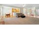 Open-concept living room with hardwood and carpet flooring, and views of kitchen and entry at 175 Georgetown Woods Dr, Youngsville, NC 27596
