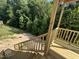 New wooden deck with railings and stairs overlooking the backyard with lush greenery at 177 Millwood Dr, Clayton, NC 27527