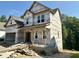 Exterior elevation of an unfinished two-story home with a covered porch, awaiting finishing touches at 177 Millwood Dr, Clayton, NC 27527