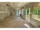 Unfinished living room area with drywall, windows, and a view to the outside porch at 177 Millwood Dr, Clayton, NC 27527