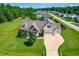 Aerial view of a well-maintained home with manicured lawn, mature trees, and a three-car garage at 20 Kola Nut, Smithfield, NC 27577