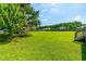Expansive backyard with lush green grass, a wooden fence, and mature trees offering privacy at 20 Kola Nut, Smithfield, NC 27577